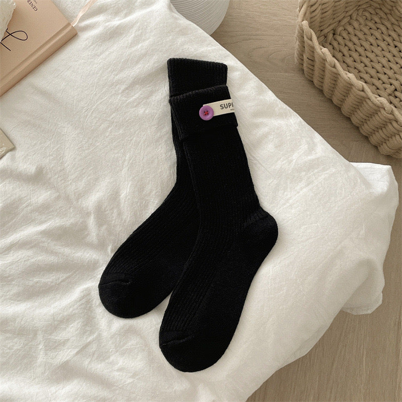 ChicToes black crew socks, with a light purple button at the ankle area