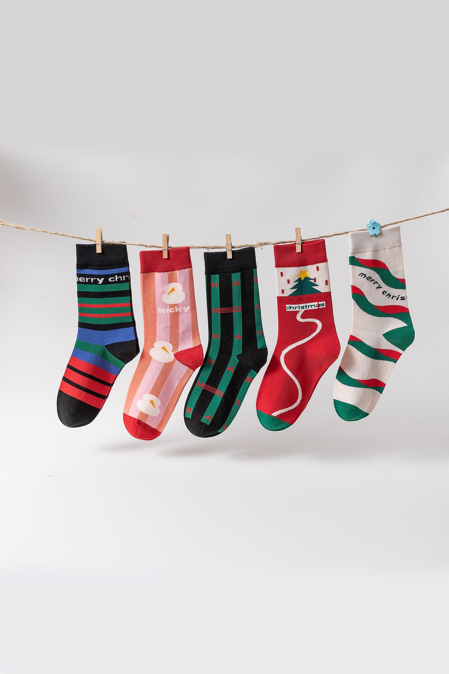 ChicToes Christmas Theme Crew Socks hanging on a string