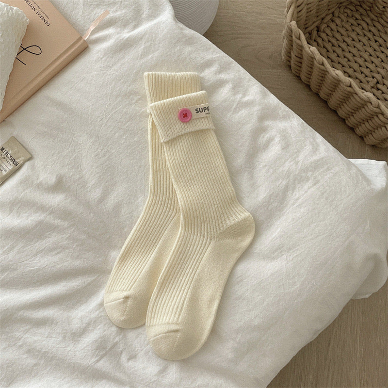 ChicToes white crew socks, with a pink button at the ankle area