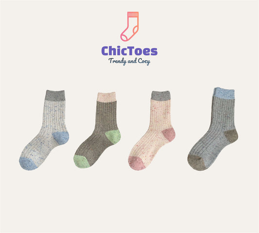 A collection of four cozy, ribbed socks displayed side by side against a neutral background. From left to right: a light grey sock with blue accents named 'Seasalt Milktea,' a deep green sock with soft green accents called 'Matcha Latte,' a pastel pink sock with muted pink accents named 'Strawberry Cream Cheese,' and a greyish-blue sock with darker grey and blue details named 'Earl Grey Shortbread.