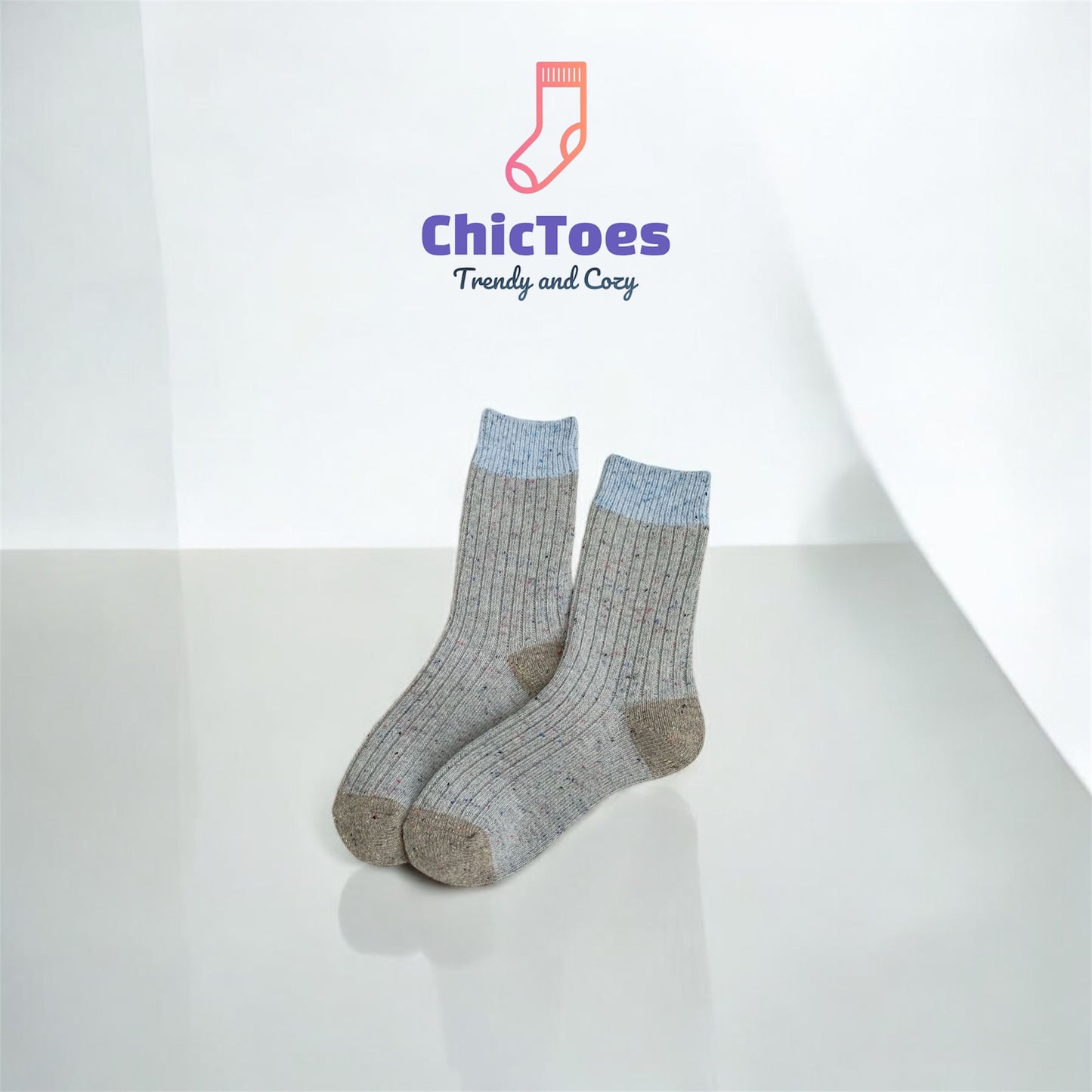 A ribbed sock in grey with hints of blue and a darker grey heel and toe, reminiscent of buttery Earl Grey Scone