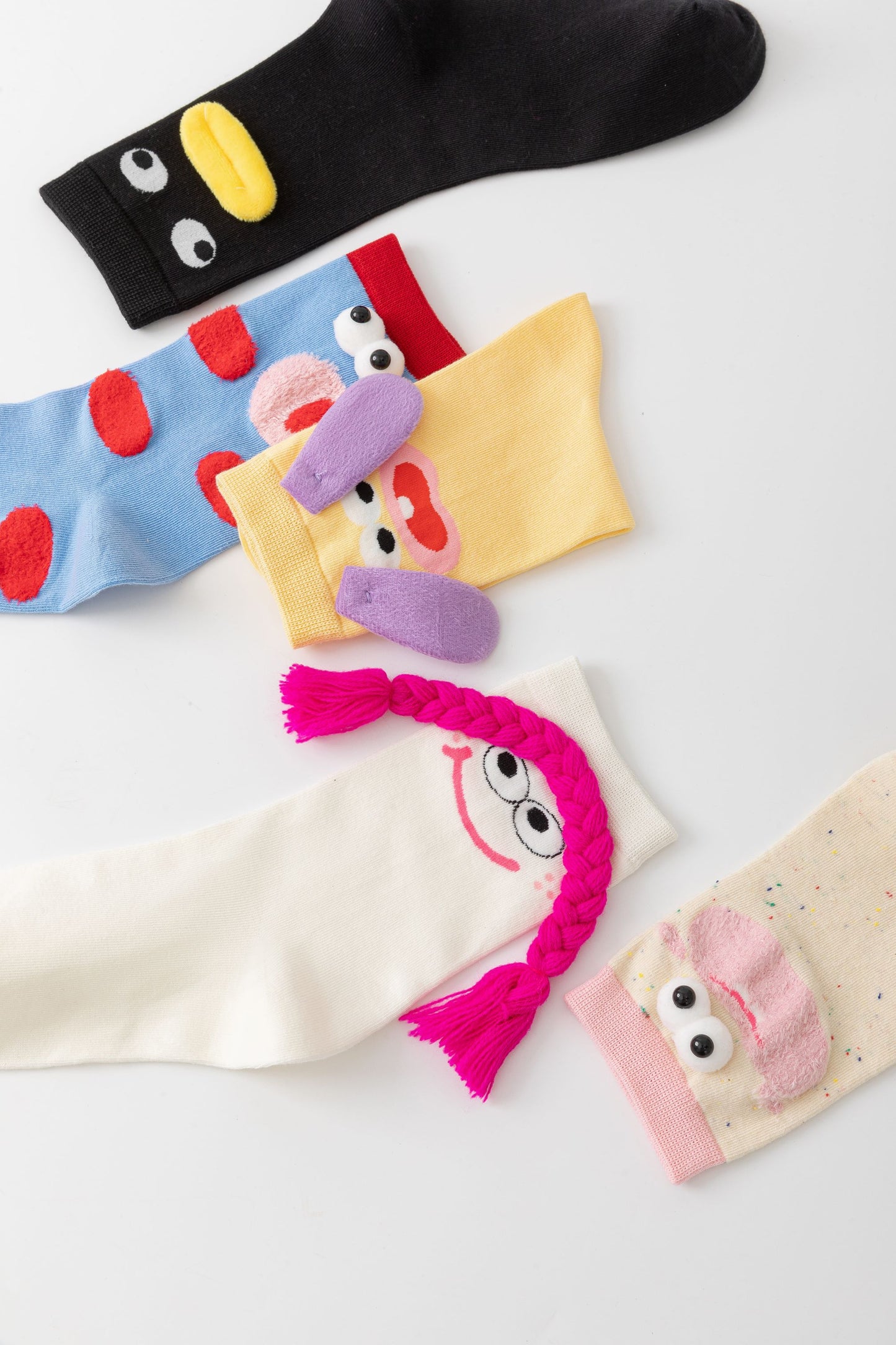 Colorful ChicToes cotton socks with playful cartoon faces and 3D details like braids and ears