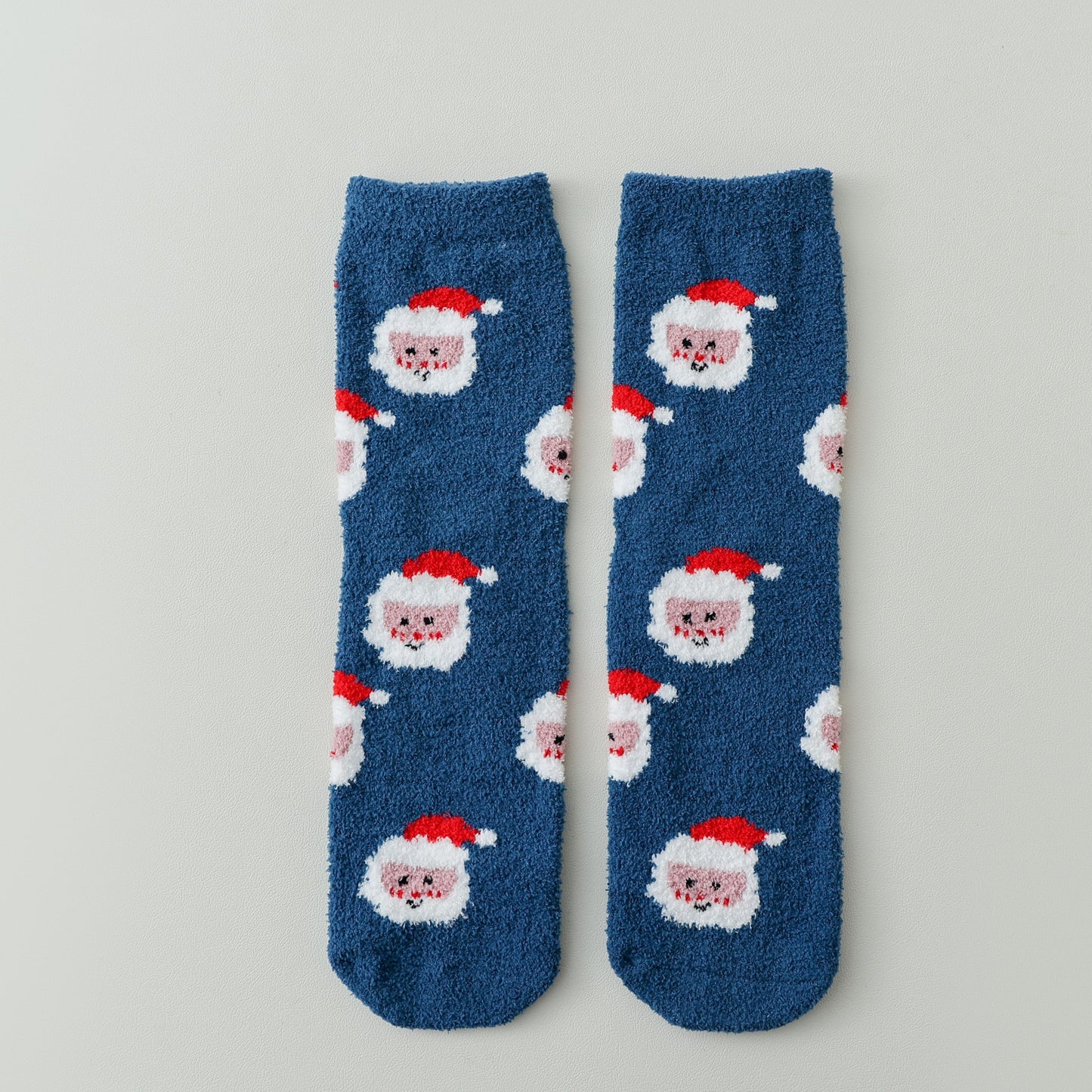 ChicToes fuzzy and cozy sleep socks in blue and santa's face pattern